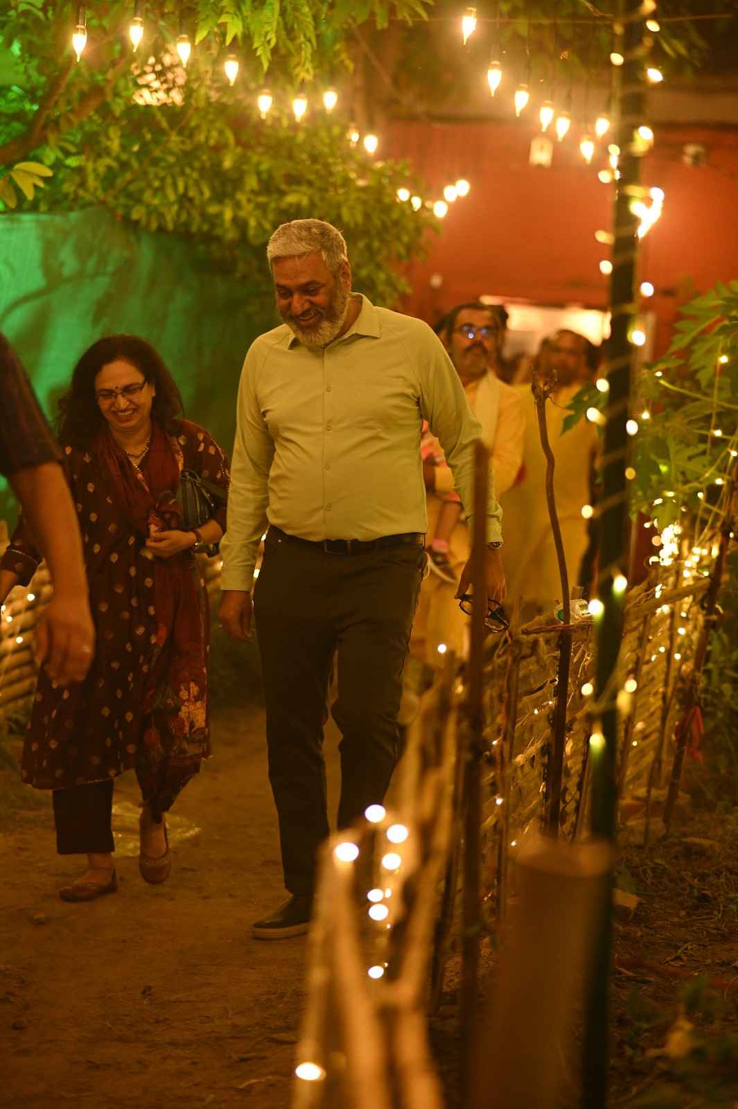 Elegant fine dining setup with a lantern on a blue tablecloth overlooking the water.